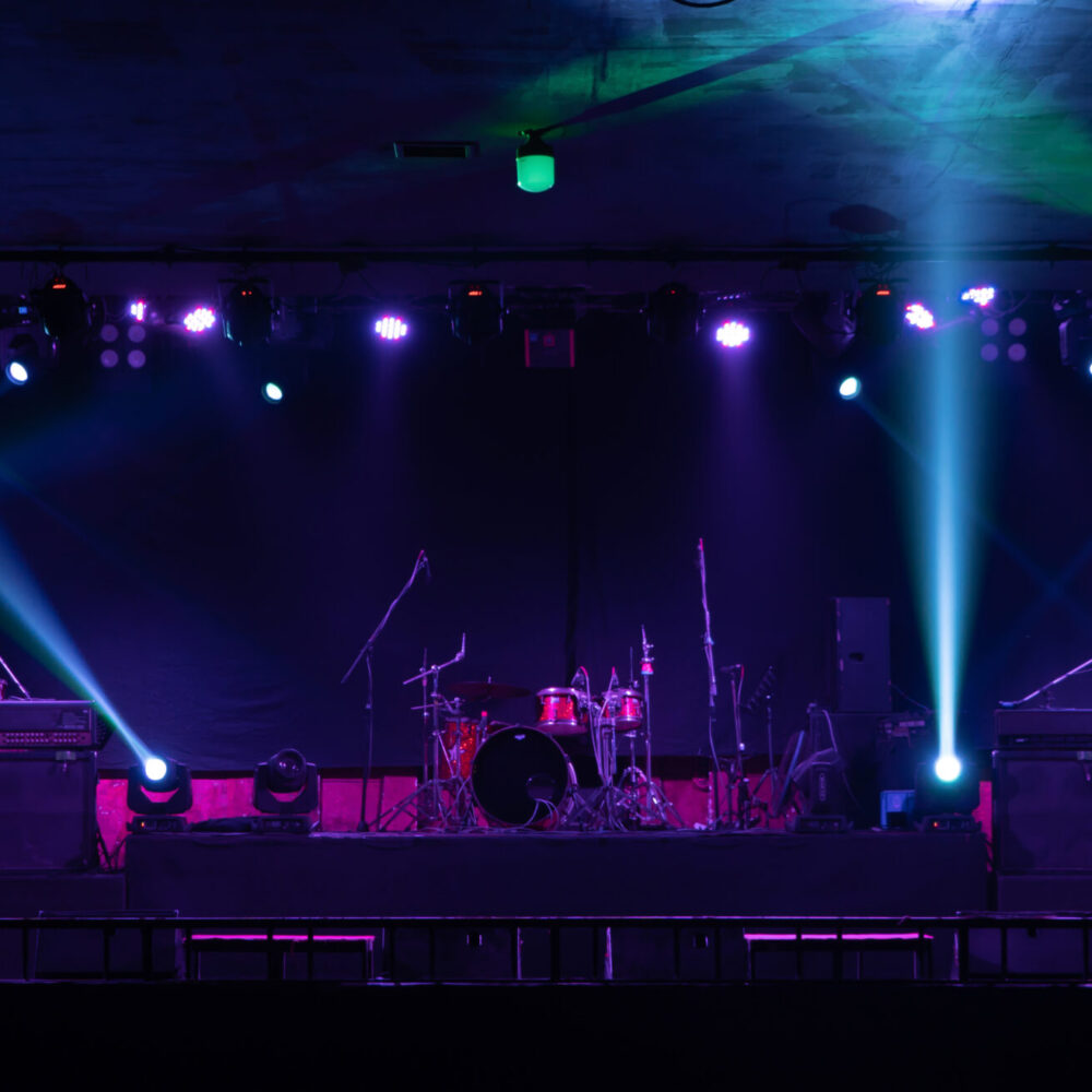 Empty stage concert with colorful lighting laser beam spotlight show in disco pub club bar background for party music dancing festival performance. Entertainment nightlife. Celebration event.